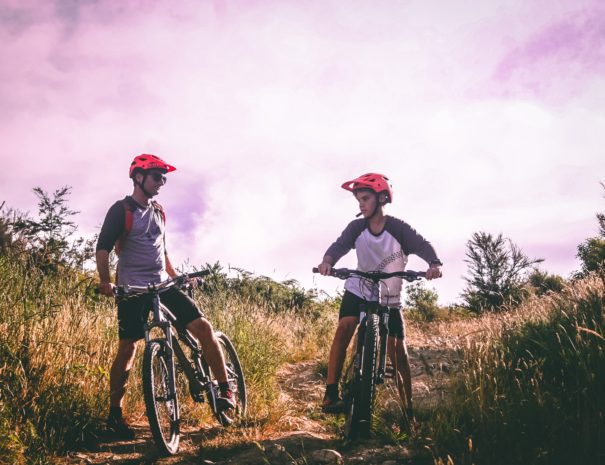 two-man-riding-mountain-bike-on-dirt-road-at-daytime-1010557